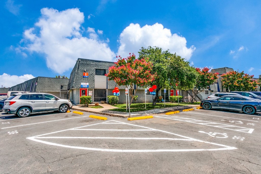 a parking lot with cars in front of a building