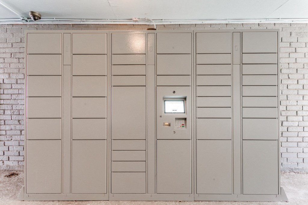 a row of lockers in a room with a brick wall