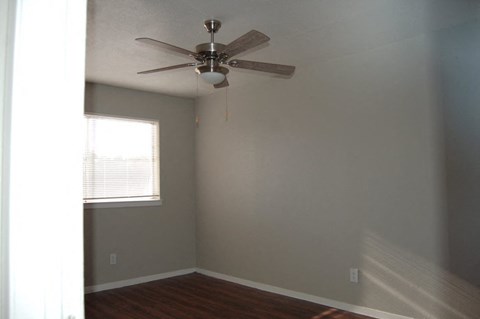 a bedroom with a ceiling fan and a window