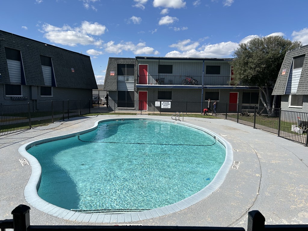 a swimming pool in front of an apartment building