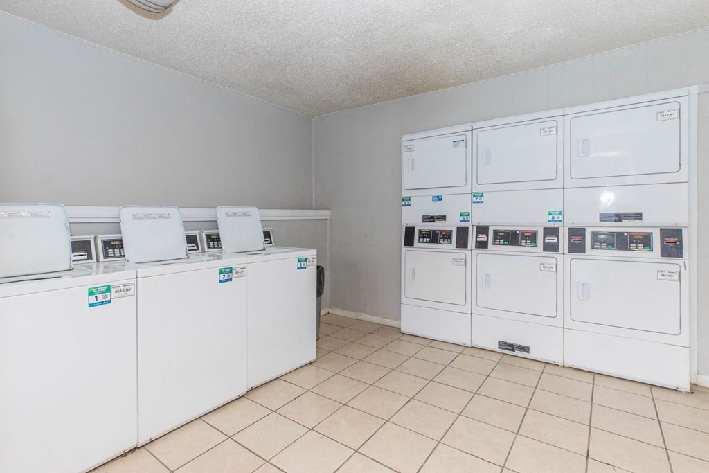 the laundry room is equipped with washes and dryers and has tile flooring