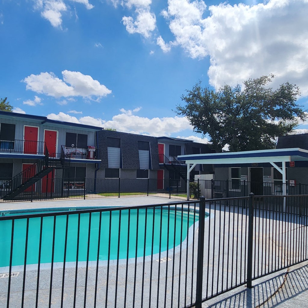 a swimming pool in front of an apartment building