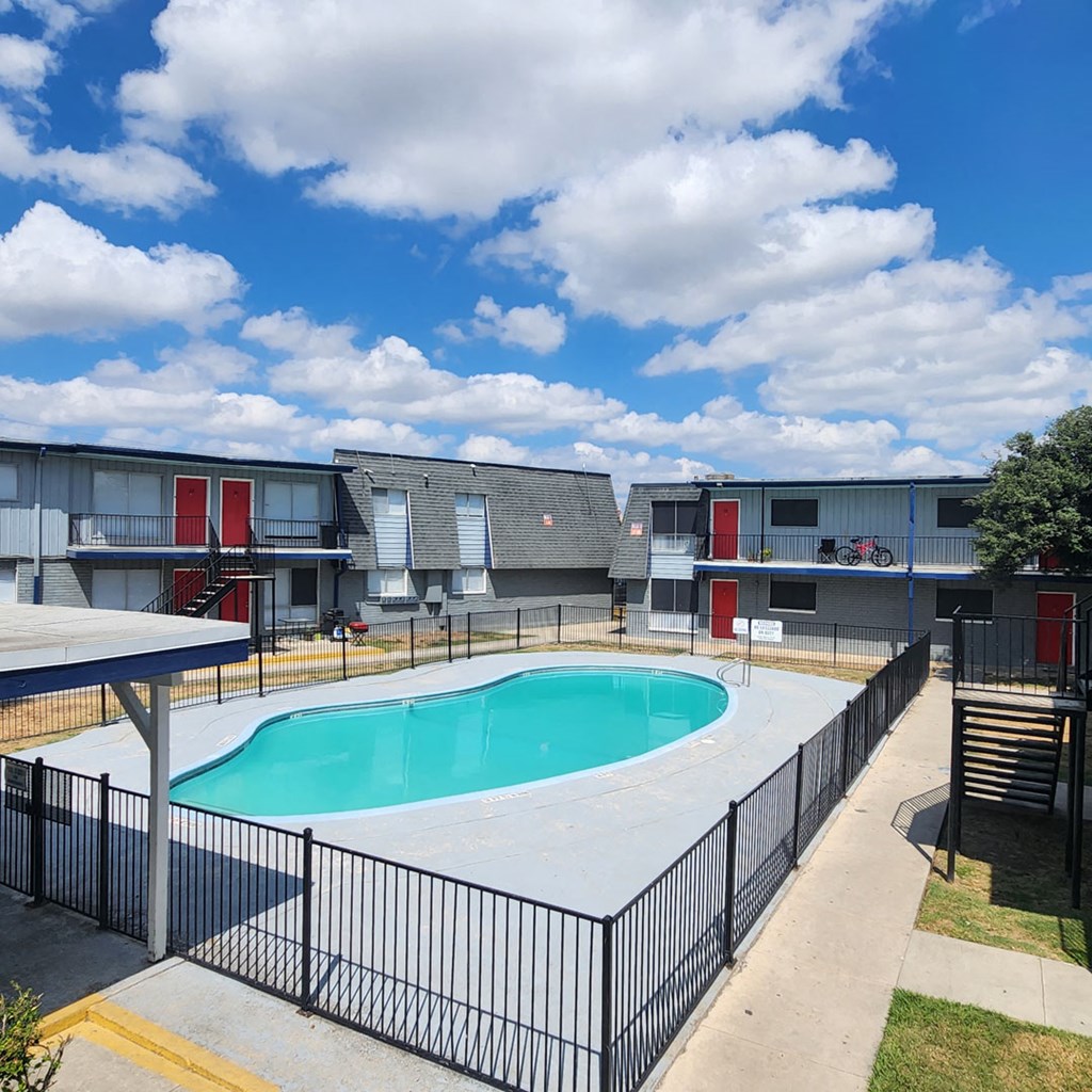 A swimming pool surrounded by a black fence.