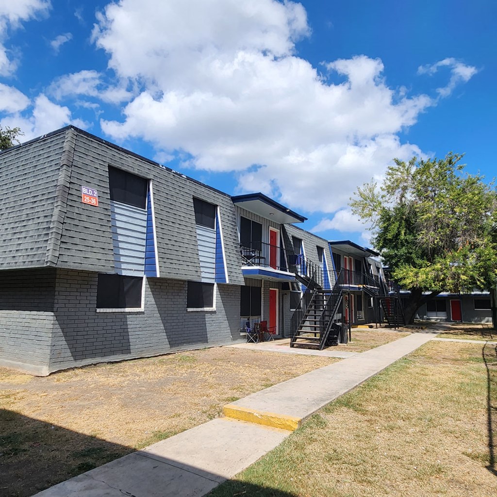 A building with a red door and a sign on the window.