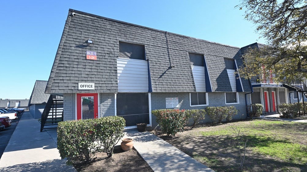 a building with a red door and a street sign