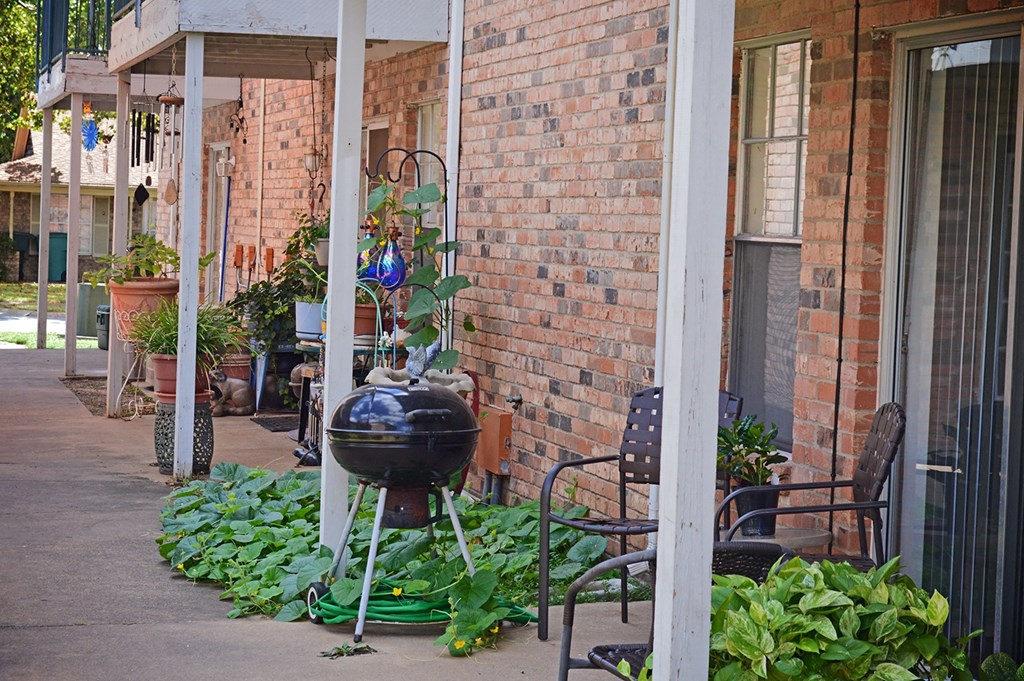 a grill on the porch of a brick building at Archer Village Apartments,Sherman, TX, 75092