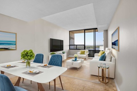 A modern living room with a dining table set for four.