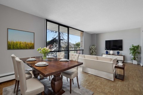 A modern dining room with a wooden table and chairs.