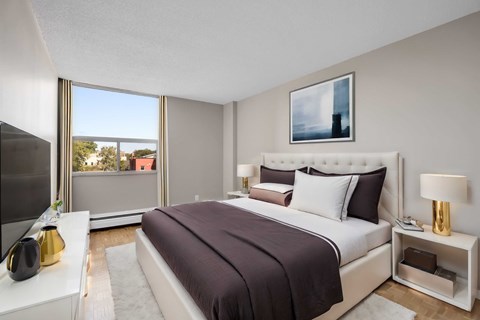 A bedroom with a large bed and a television.