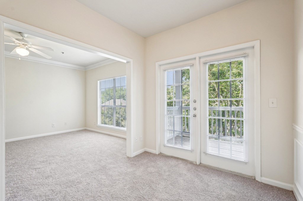 Living and dining room with carpeted floor, and windows