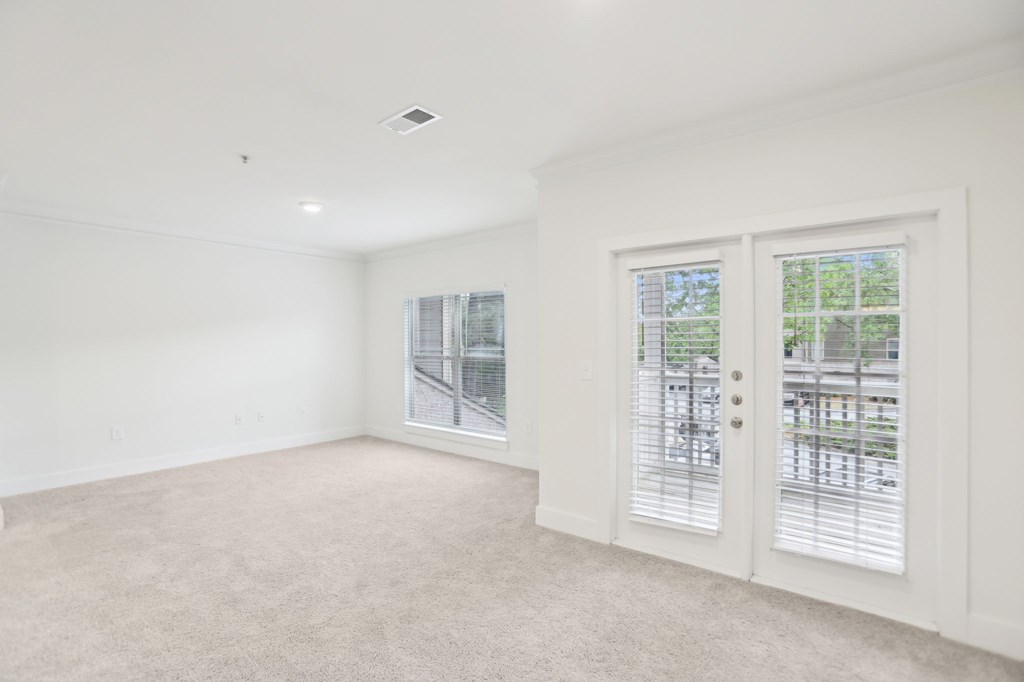 Spacious living room with big windows and natural light
