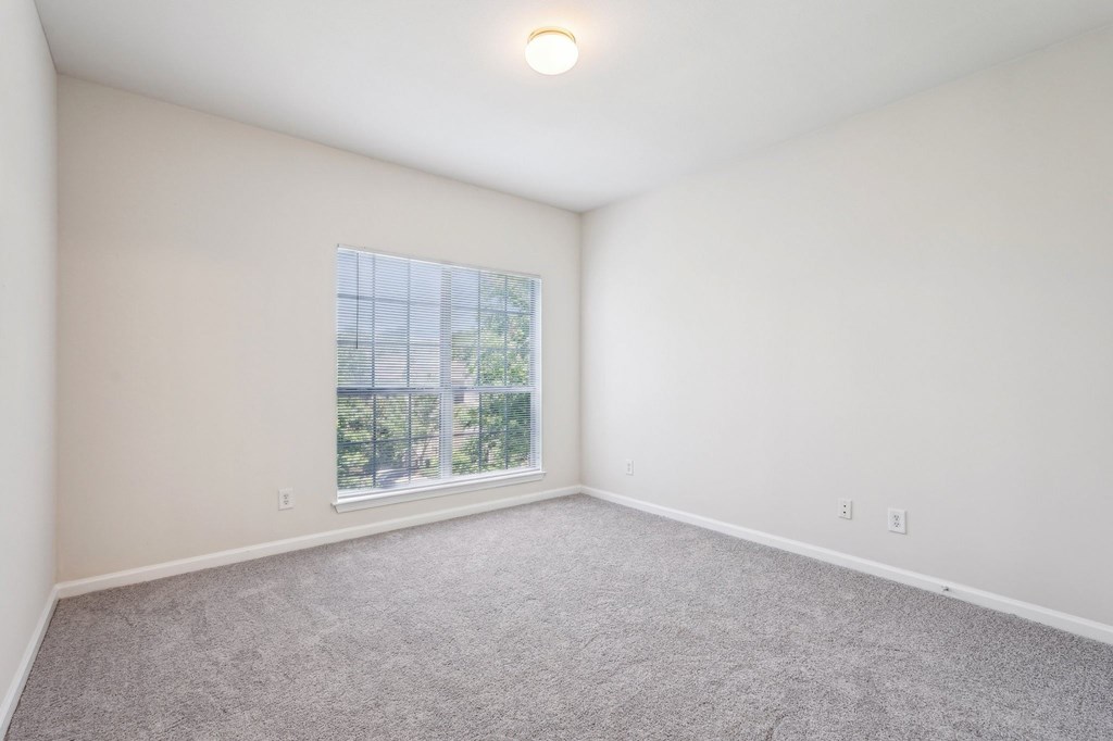 A big bedroom with a window