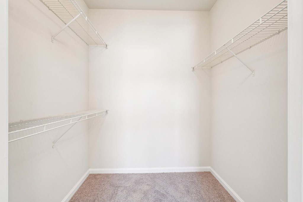 A large walk-in closet with shelves.
