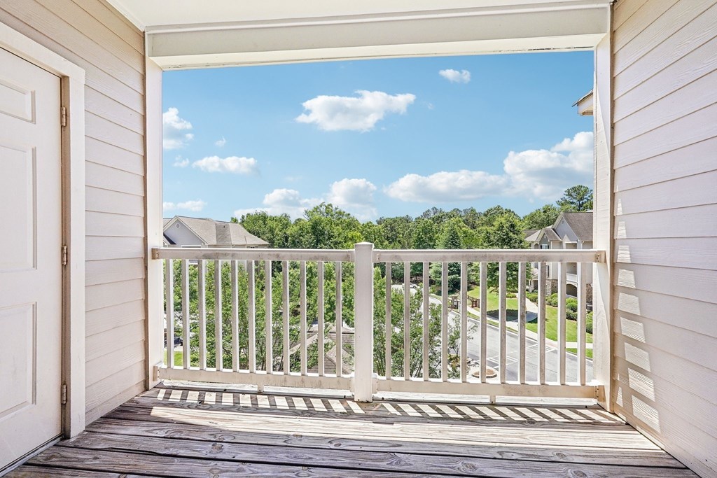A view from a porch looking out at a residential neighborhood.