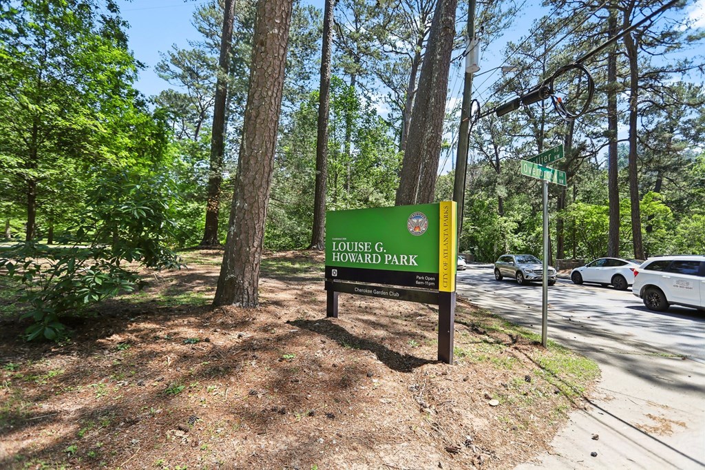 Louise G. Howard Park sign in front of trees.