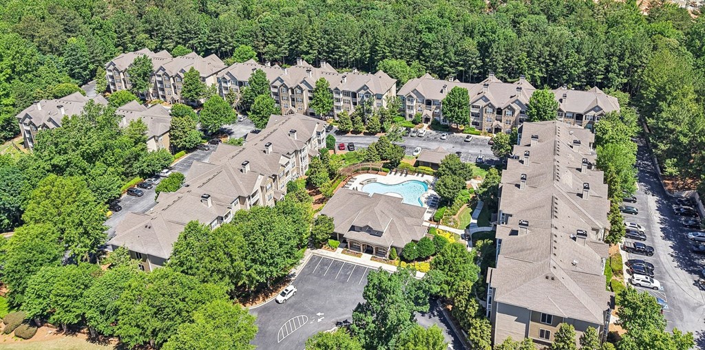A bird's eye view of a residential complex with a swimming pool.