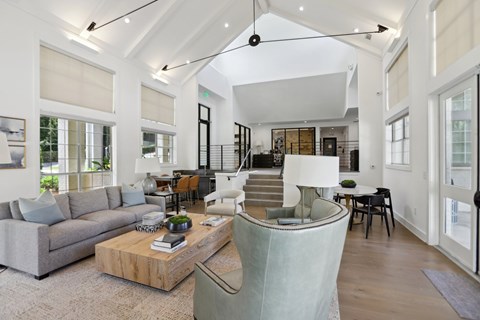 A modern living room with a grey sofa and a wooden coffee table.