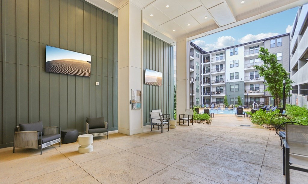 A modern building lobby with a green wall and a large painting.