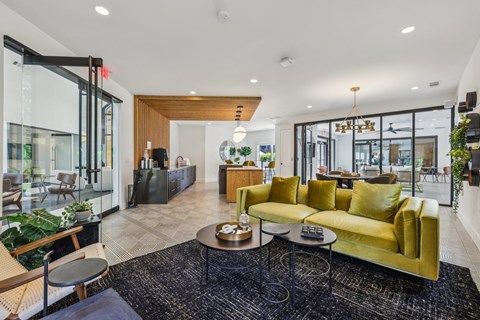 A modern living room with a yellow sofa and a coffee table.
