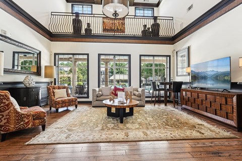A living room with a large rug and a coffee table.