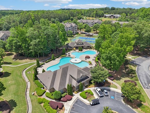 Birds eye view of the community and  a pool and  tennis court.