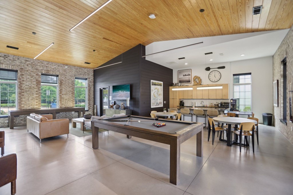 Resident clubhouse with a tv, billiards, dining and bar area with kitchen and coffee machine