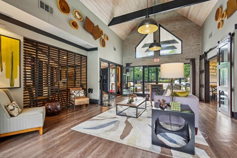 A modern living room with a grey sofa and a wooden floor.