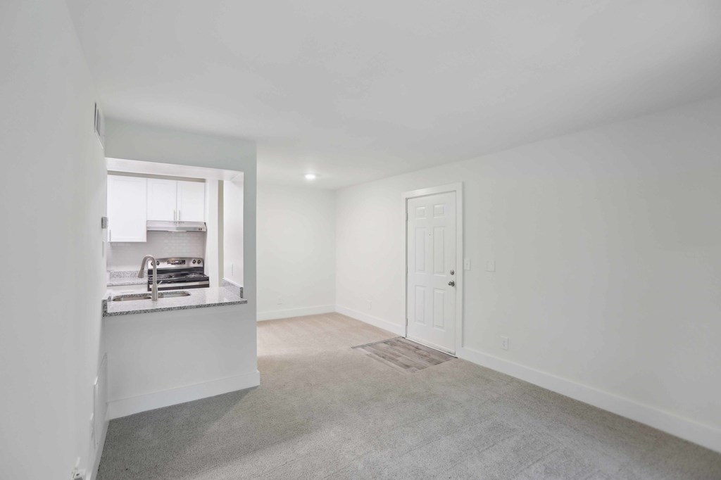 Living room with the view of the kitchen and dining room.