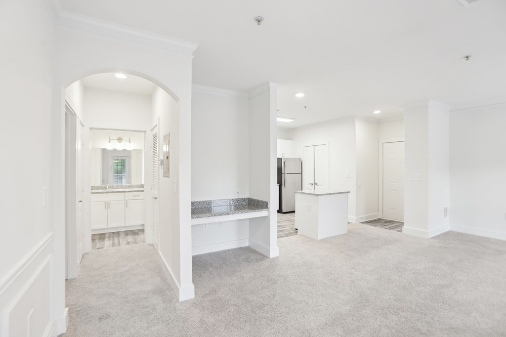 Living and dining area with a view of  a hutch desk and bathroom
