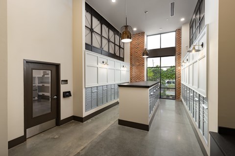 A modern kitchen with a white counter and a black fridge.
