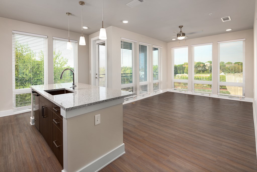 A modern kitchen with stainless steel appliances and floor to ceiling windows
