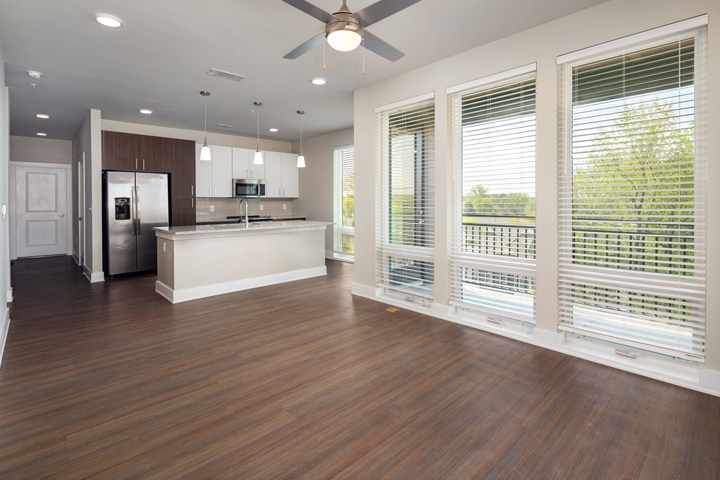 A modern kitchen with stainless steel appliances and floor to ceiling windows