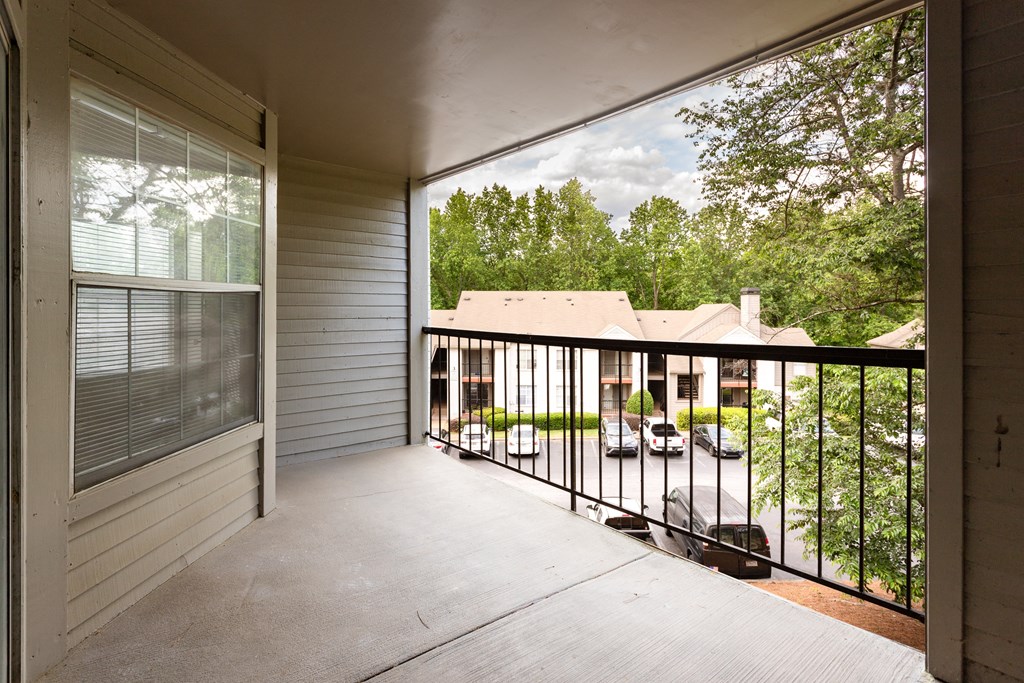 the view from the balcony of a home with a large screen porch
