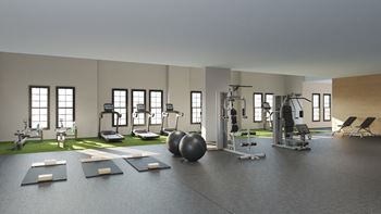 A spacious gym with a variety of equipment.