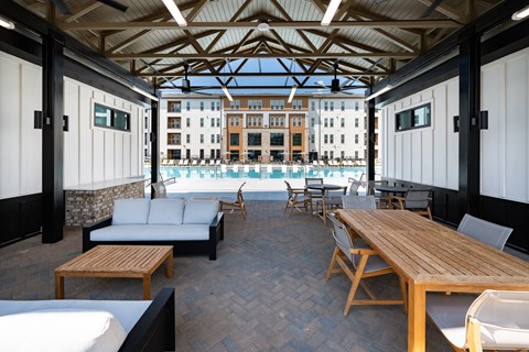 A wooden table and chairs are set up on a patio.