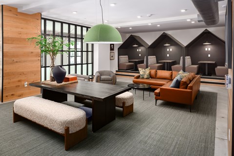 A modern living room with a large wooden table and comfortable seating.