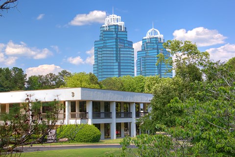 A white building with a green lawn in front of it.