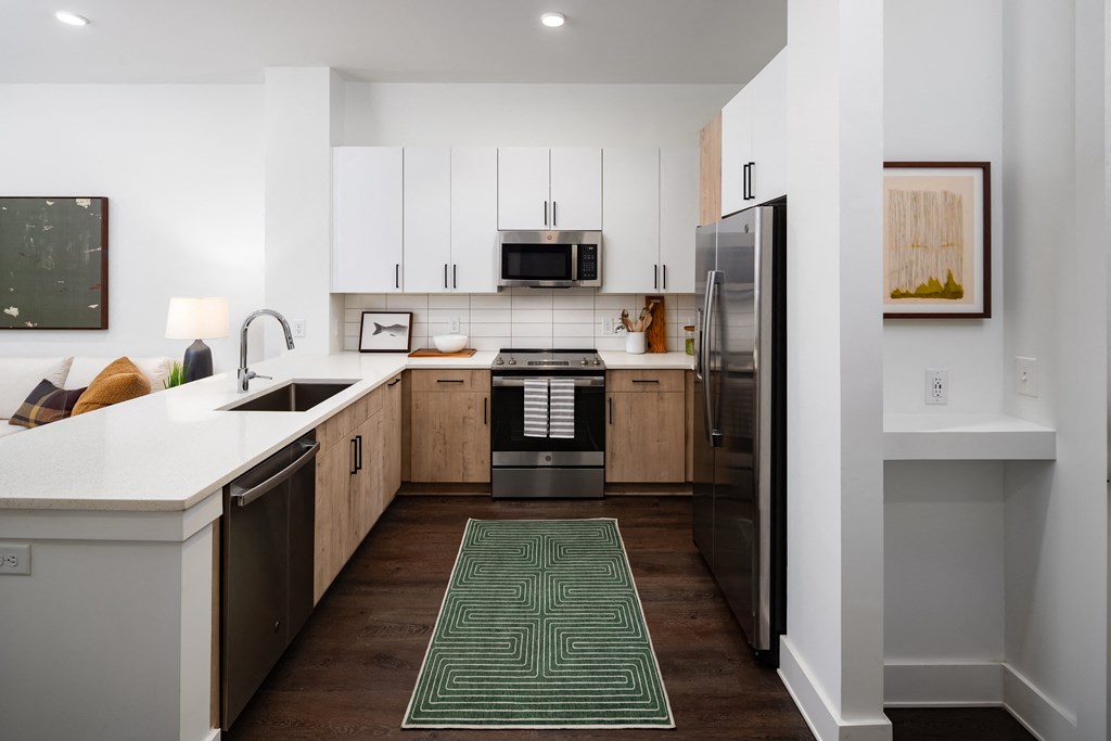 a kitchen with white cabinets and stainless steel appliances