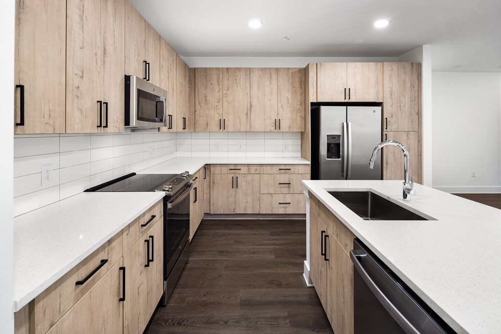 A modern kitchen with wooden cabinets and stainless steel appliances.