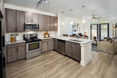 A modern kitchen with wooden cabinets and a granite countertops