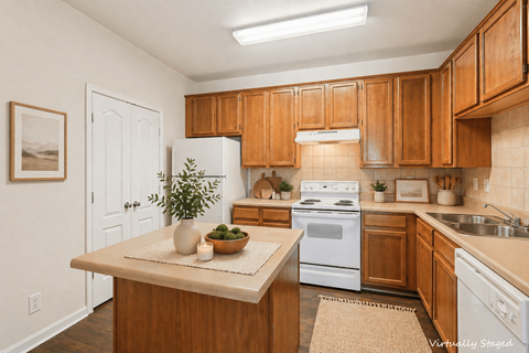 A kitchen with wooden cabinets and a white fridge.