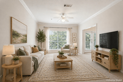 A living room with a couch, a coffee table, a television, and a painting on the wall.