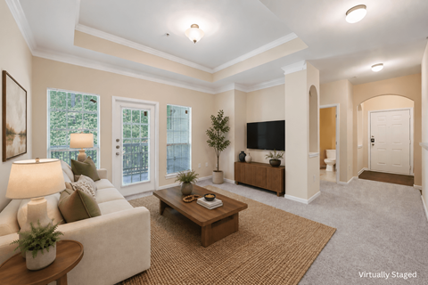 A living room with a couch, coffee table, and television.