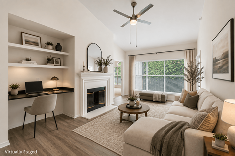 A living room with a fireplace, a couch, and a chair.