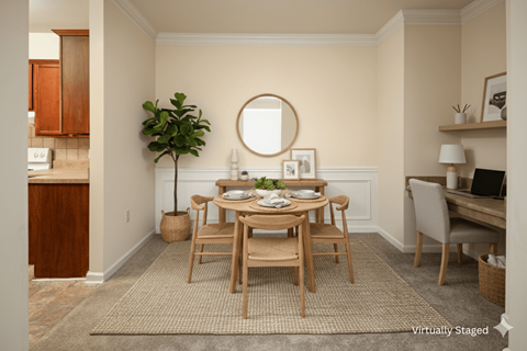A dining room with a round mirror and a dining table with chairs.