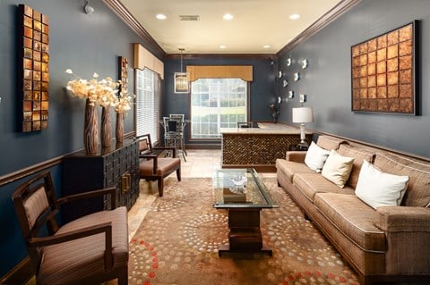 a living room with blue walls and a brown couch