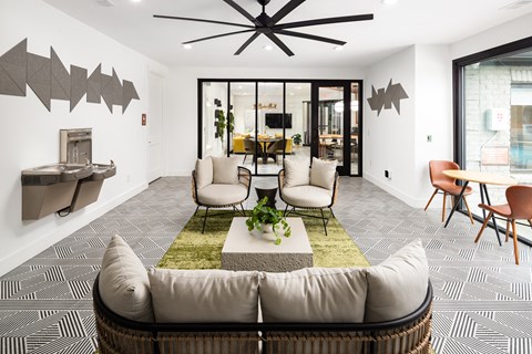 a living room with a couch and a table with chairs