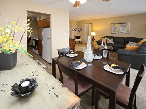 Dining room with table settings and living area at Harbor Crest Apartments, Euclid