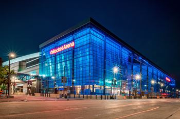 The Rocket Arena is a large, modern building with a glass facade and blue lighting.