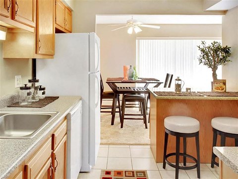 a kitchen and dining room with a table and a refrigerator